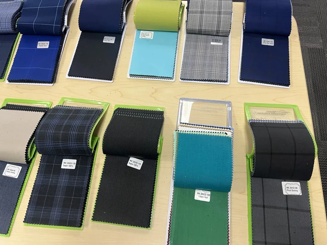 Suiting fabric swatches in blue, gray, teal and other colors